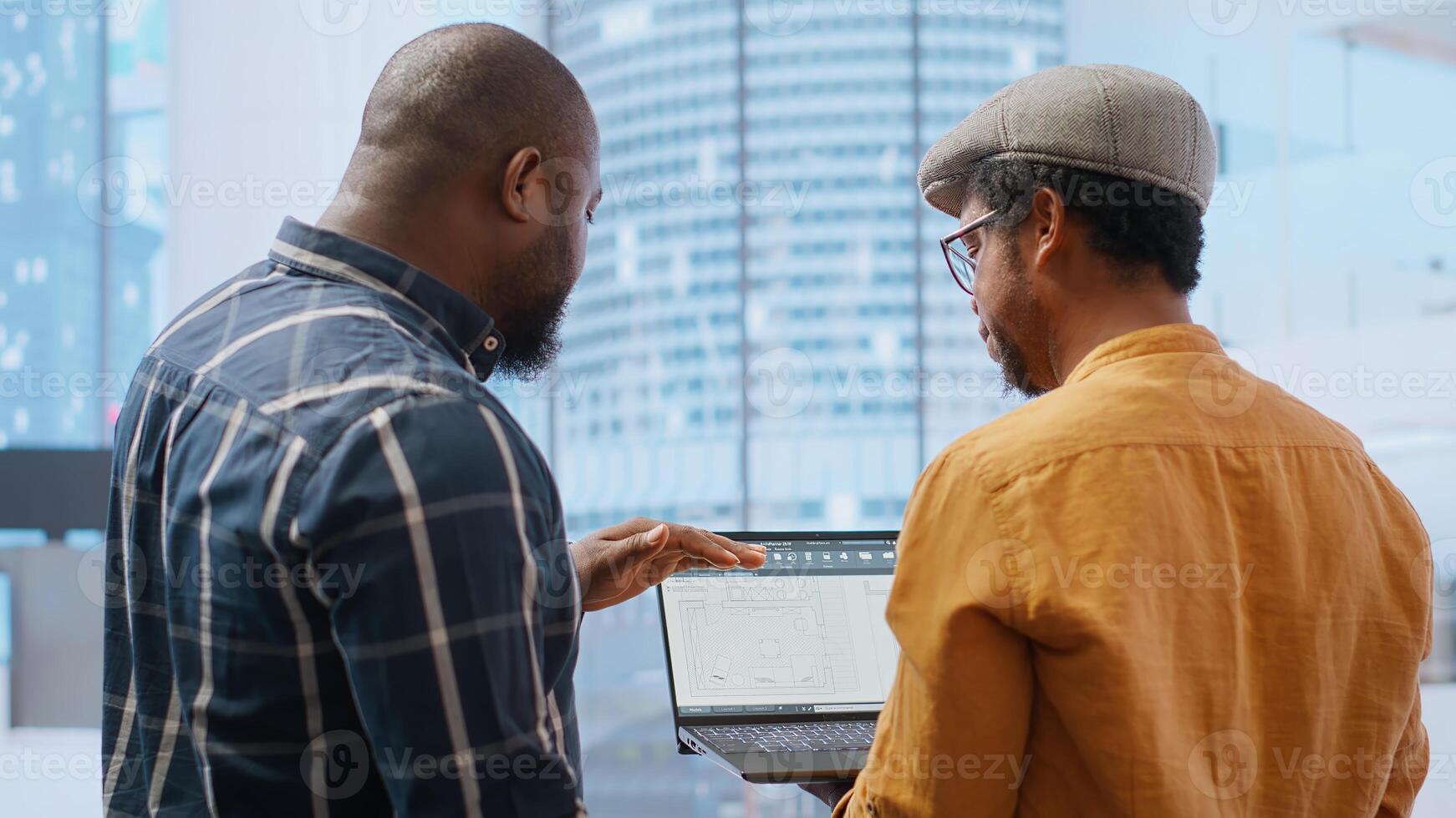 Corporate clients evaluating an investment opportunity in real estate, reviewing architectural blueprints and discussing the best strategies for office relocation and creative development. Camera B. photo