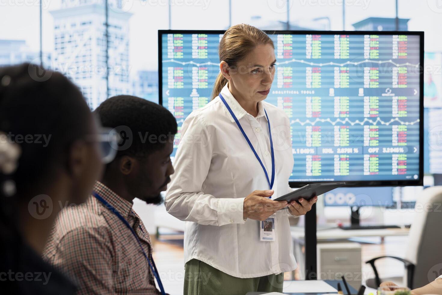 Diverse work team collaborating on project management tasks, utilizing smart technology and detailed analytics to optimize resource allocation and ensure enterprise objectives. photo