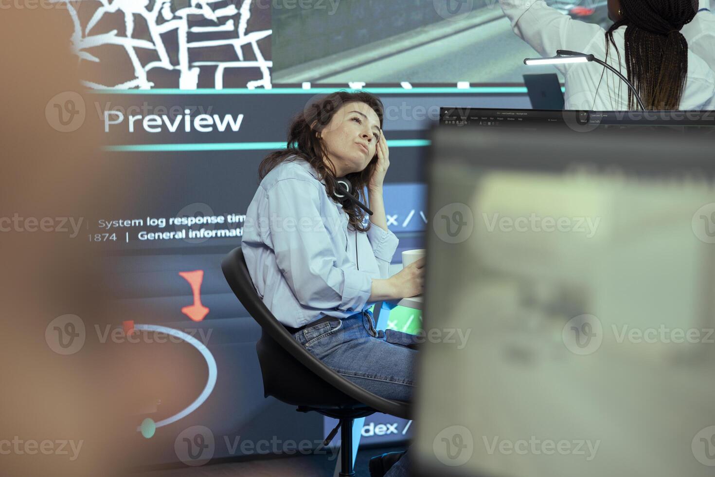 Stressed operator working under pressure in monitoring room headquarters, failing to properly follow couriers around town. Employee feels frustrated at her workplace, order tracking. photo