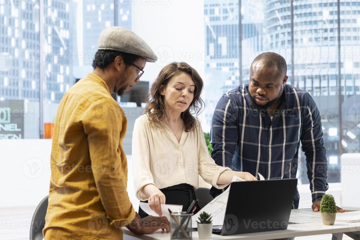 Entrepreneur engage in a planning session with a real estate agent on office tour, evaluating architectural blueprints and strategizing the layout of a new modern workspace for leasing. photo