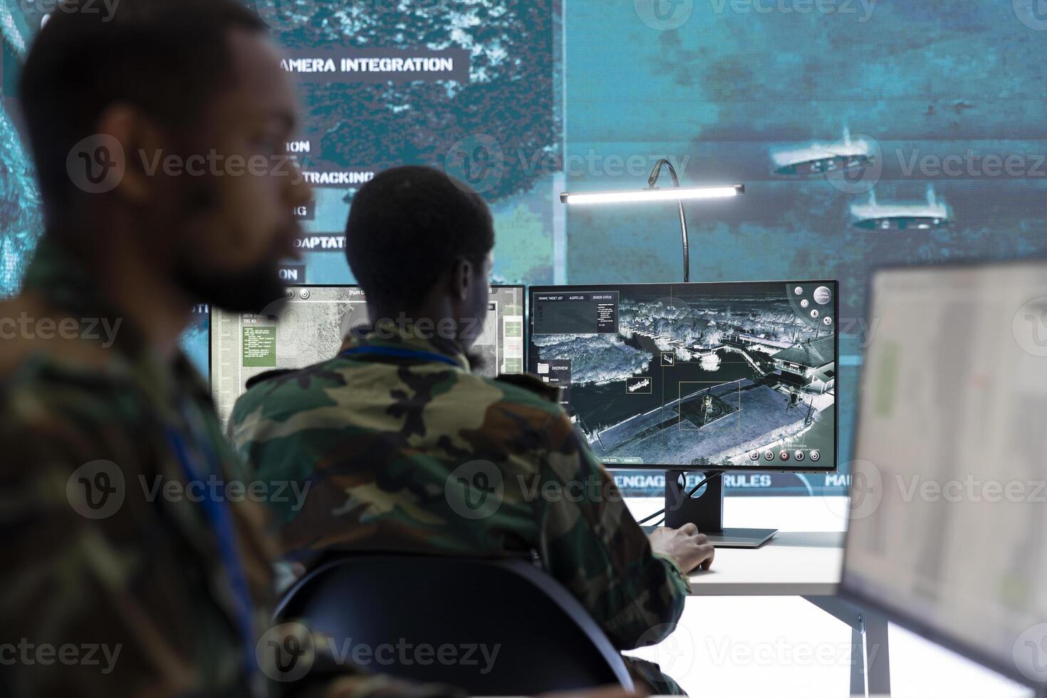 Soldiers in a state of the art military control room collaborate on data analysis, intelligence gathering, and mission planning. Their efforts ensure the effectiveness and security of military operations. photo