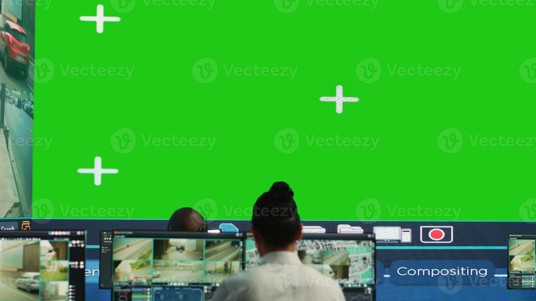 Courier agency operators monitoring cargo shipment with a greenscreen, working in observation room. Employees give directions to truck drivers stuck in traffic, CCTV system. Camera A. photo