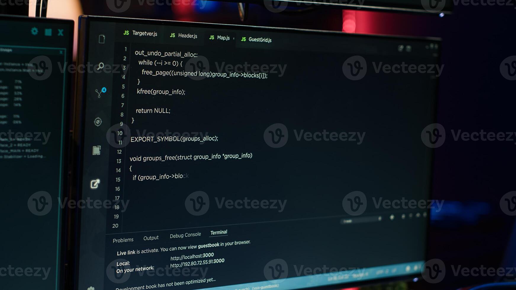 Extreme close up of software interface on PC screens showing lines of code running in empty criminals den. Hacking malware programming script on displays in underground base, handheld camera shot photo