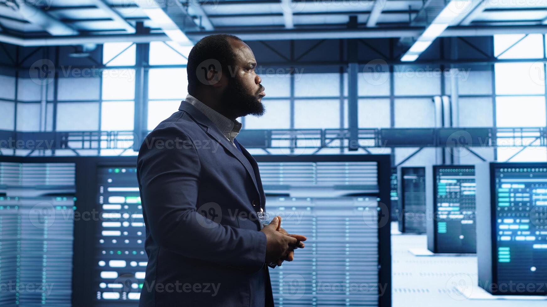 Admin inspecting server farm equipment, walking between supercomputers. IT specialist doing evaluation of data center workspace, checking equipment, monitoring performance, camera A photo