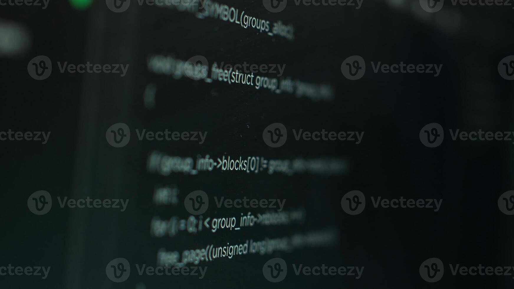 Extreme close up shot of hacking code running on computer system monitors attacking firewalls. Programming scripts shown on PC screen used by cyber criminals to breach security photo