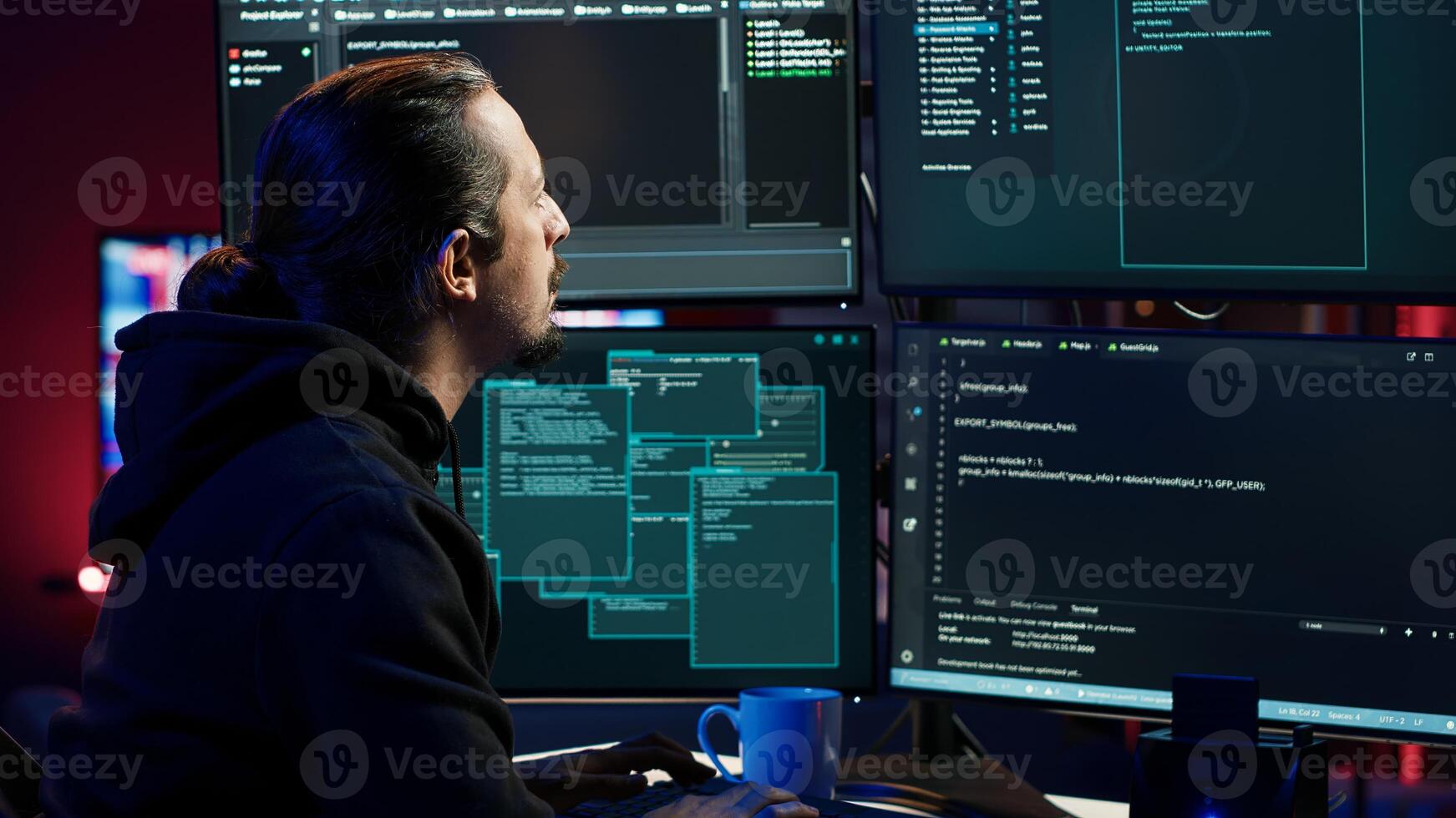 Hacker typing fast on keyboards, rushing to finish developing spyware software, using it to gather data from users computers without their knowledge. Scammer writing malicious code, camera A photo