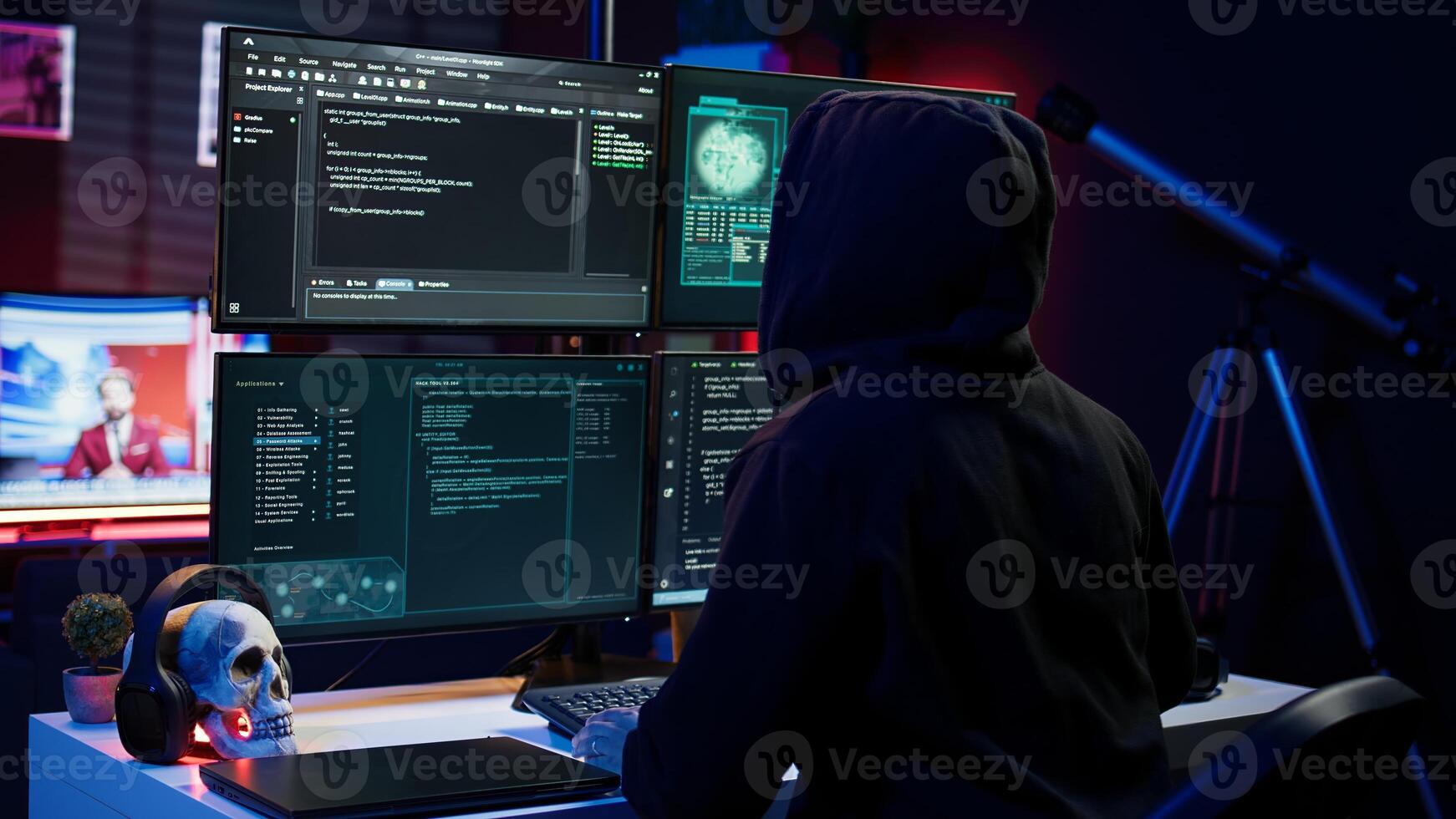 Hacker arriving in underground HQ, ready to start coding malware designed to exploit network backdoors and bypass security measures such as logins and password protections, camera B photo