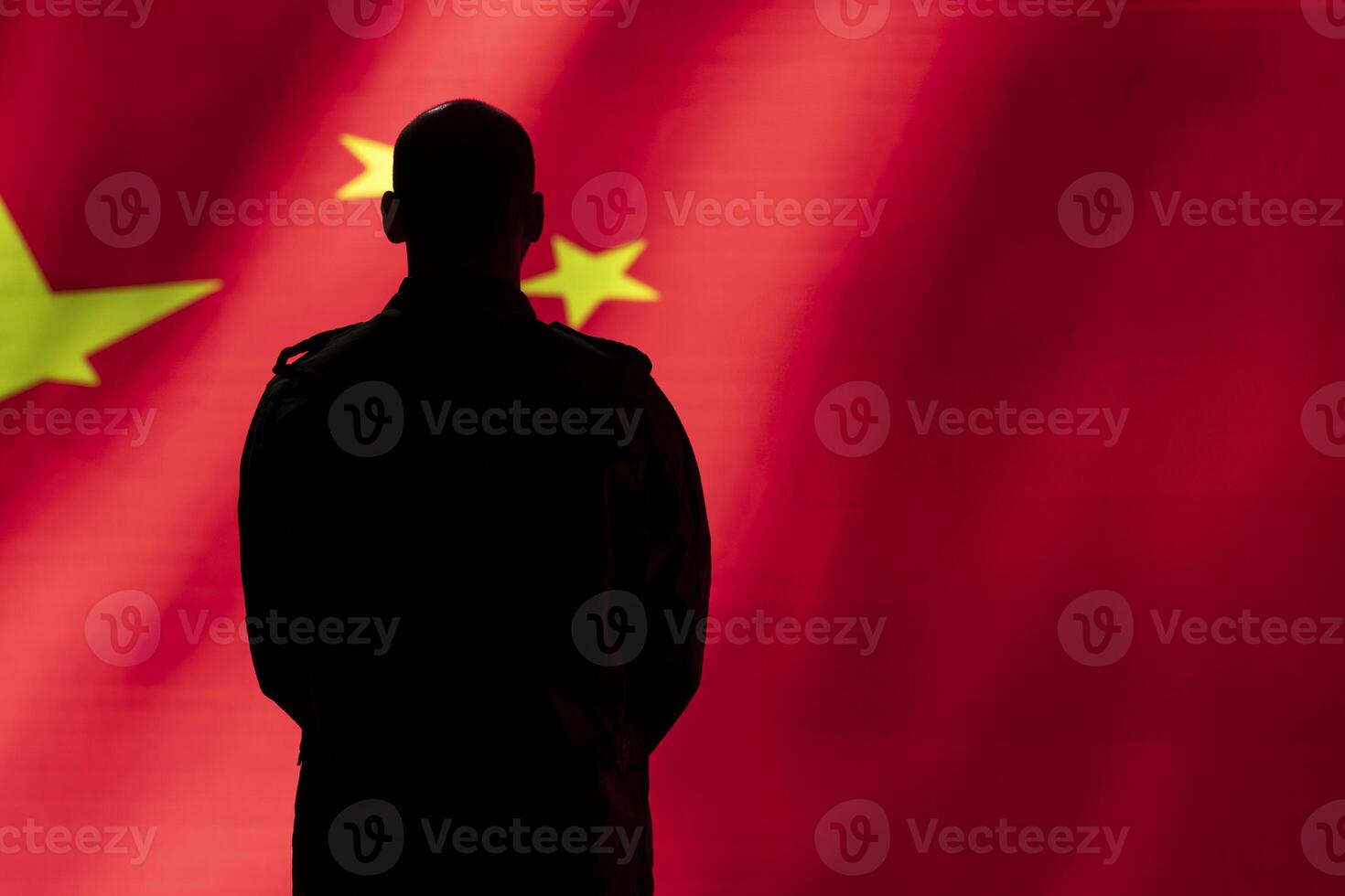 CCP government agent standing proud in front of Chinese flag, feeling pride in serving country. Chinese army personnel in war room standing isolated over China flag background photo