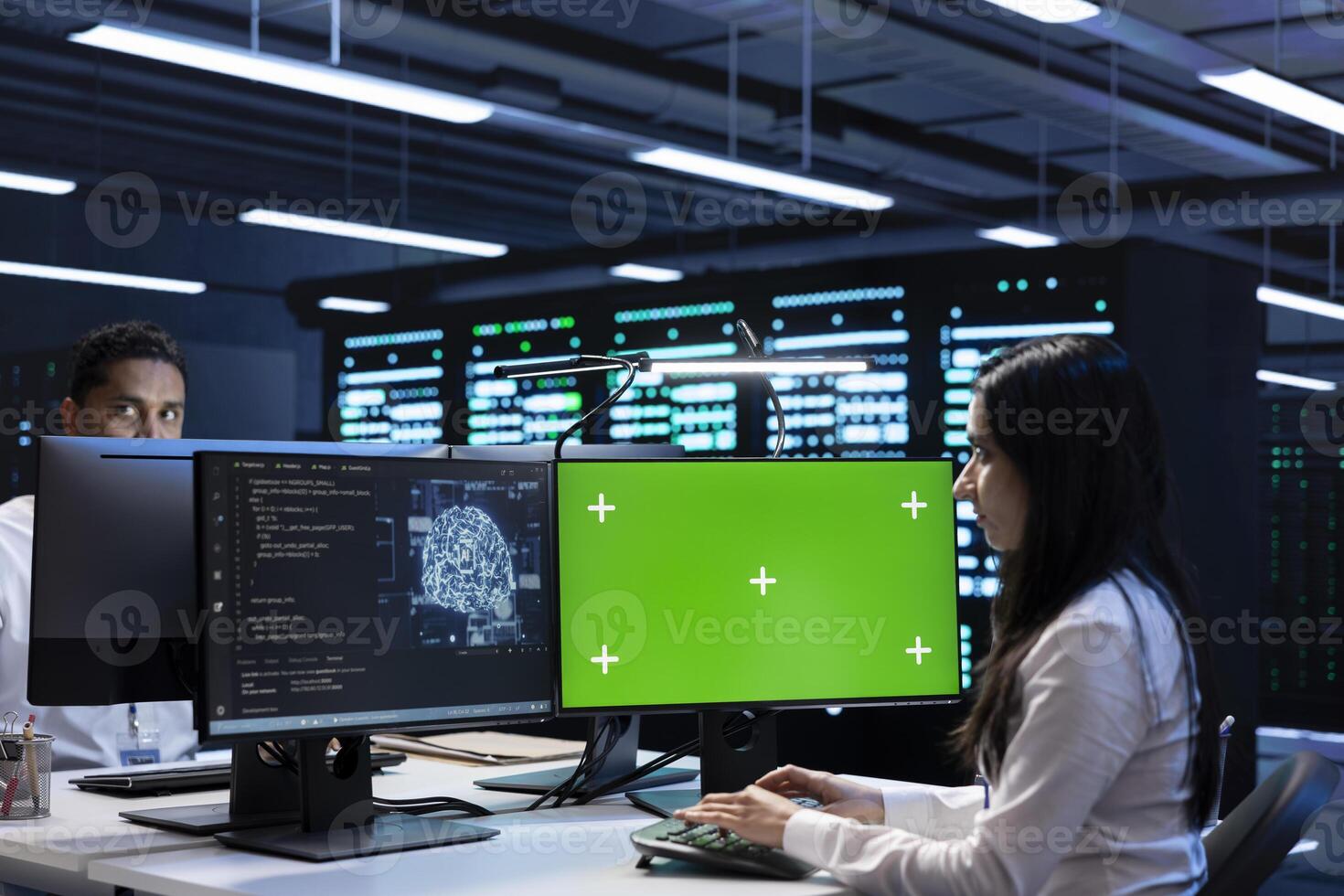 Team of technicians doing maintenance on green screen computer in server hub used for artificial intelligence workloads. Teamworking employees inspecting neural network data center with mockup PC photo