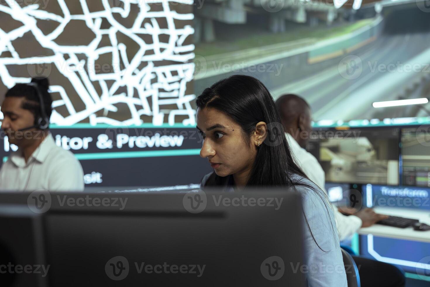 Indian employee following delivery trucks in traffic via mobile map with gps tracking, monitoring location and destination to ensure parcel shipment. Woman uses public surveillance cameras. photo