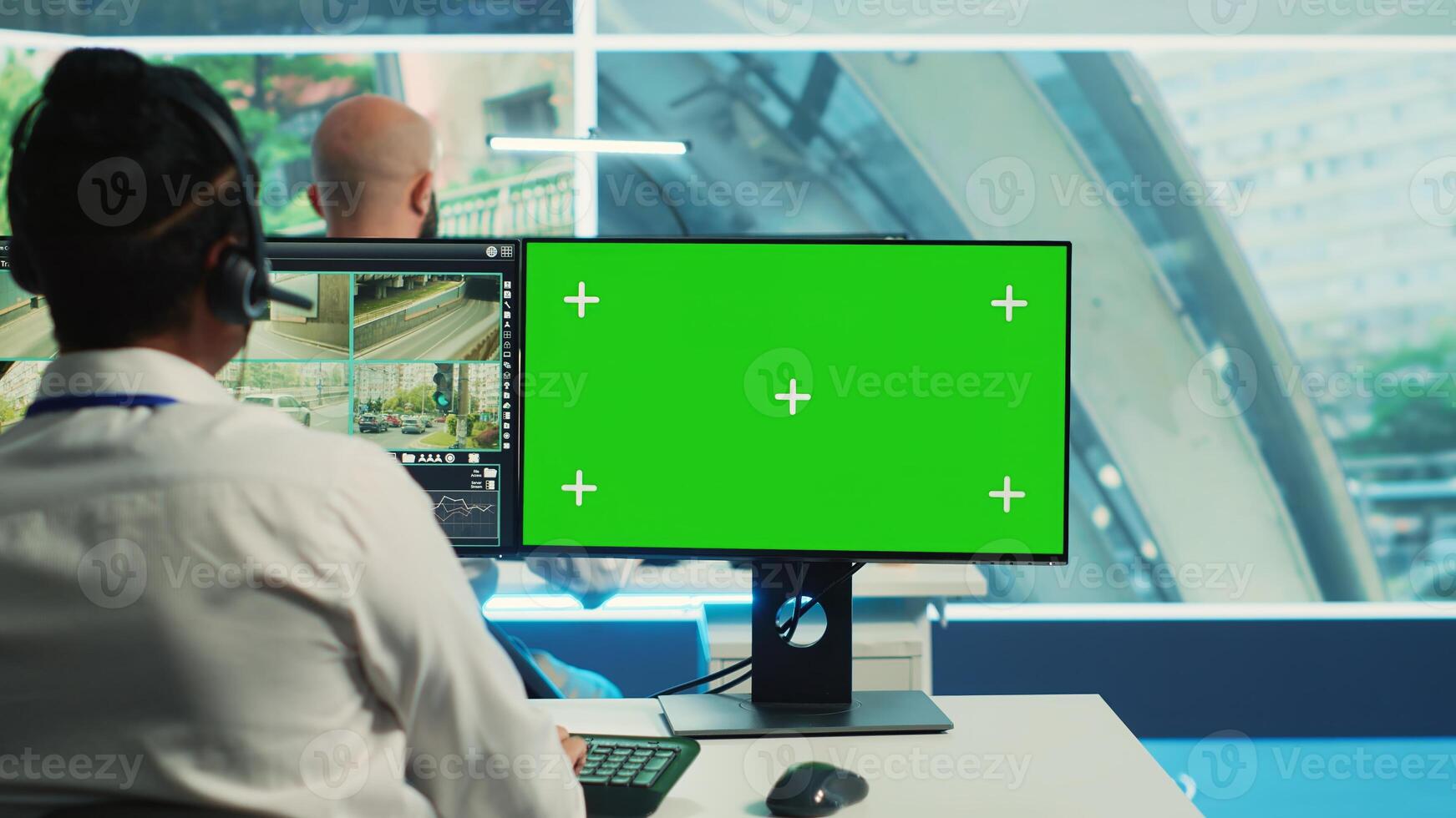 Indian employee uses greenscreen and surveillance CCTV footage to monitor the city traffic, ensuring public safety. Agency worker looking at security system camera recordings. Camera A. photo