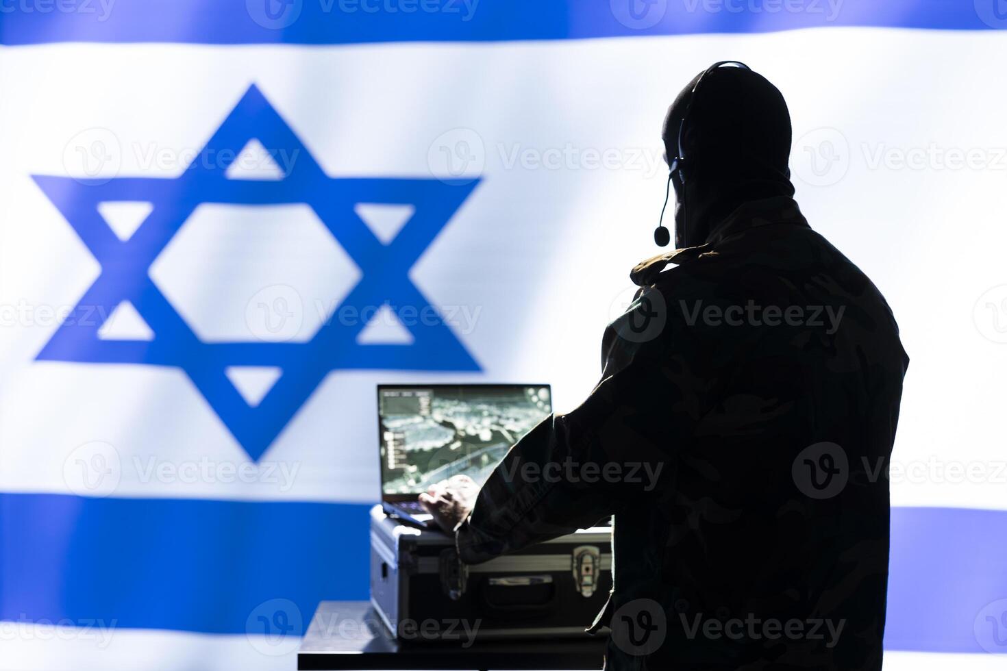 Iranian conscript in command room uses military tech to identify threats from enemies. Iran IDF army operator uses software on laptop to communicate information to generals on war front line photo