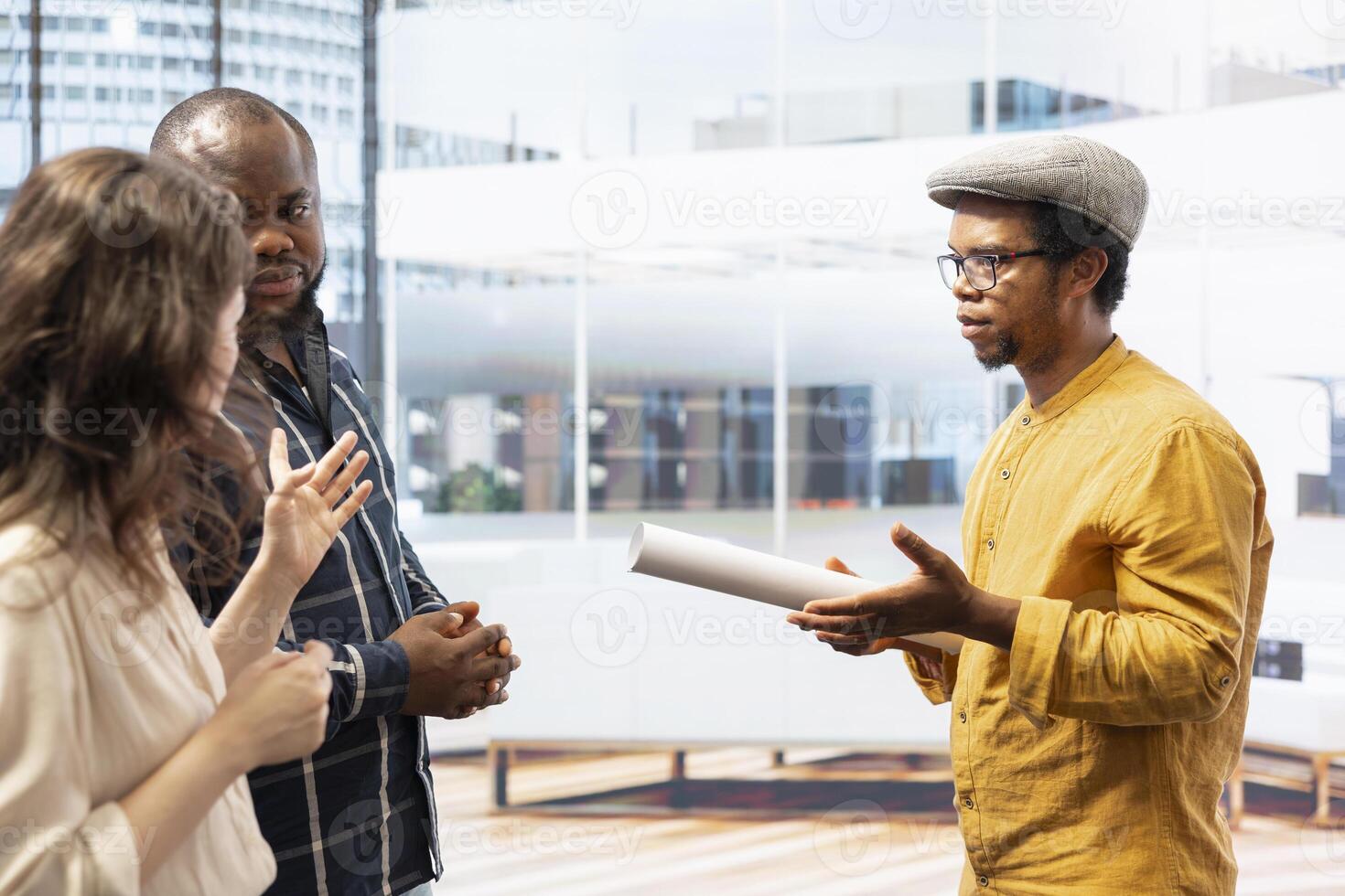 Clients and realtor touring a modern office space for relocation, reviewing modern property blueprints and plans. Business owner negotiating high class urban building investment strategy. photo