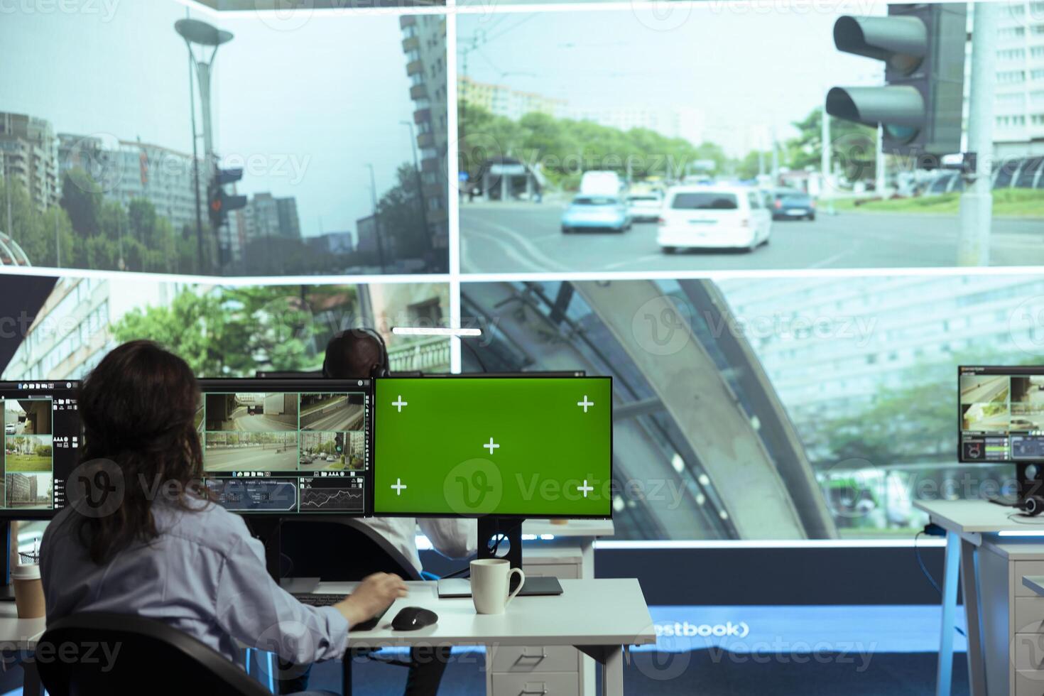 Agency worker using real time CCTV footage and mockup screen, monitoring traffic through surveillance in observation room. Employee works within the government radar system. photo