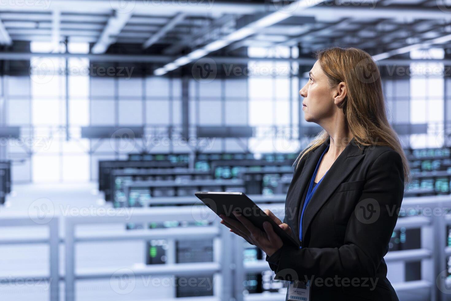 Computer scientist doing disaster recovery planning and security protocol enforcement in data center. IT staff member in server room working to reduce downtime, ensuring business continuity photo