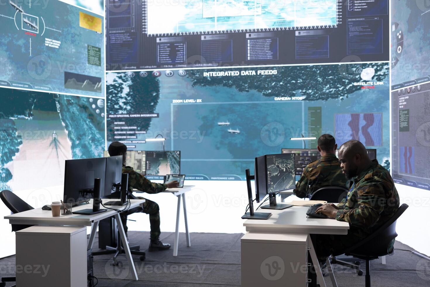 Army staff in a high tech control room managing crucial defense information, gathering live surveillance data to maintain security protocols. Military crew members working on reconnaissance. photo