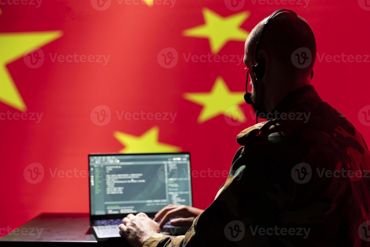 Chinese army telecommunication systems operator using radio and satellite tech, talking in headphones mic. China military dispatcher managing communications networks, typing on device photo