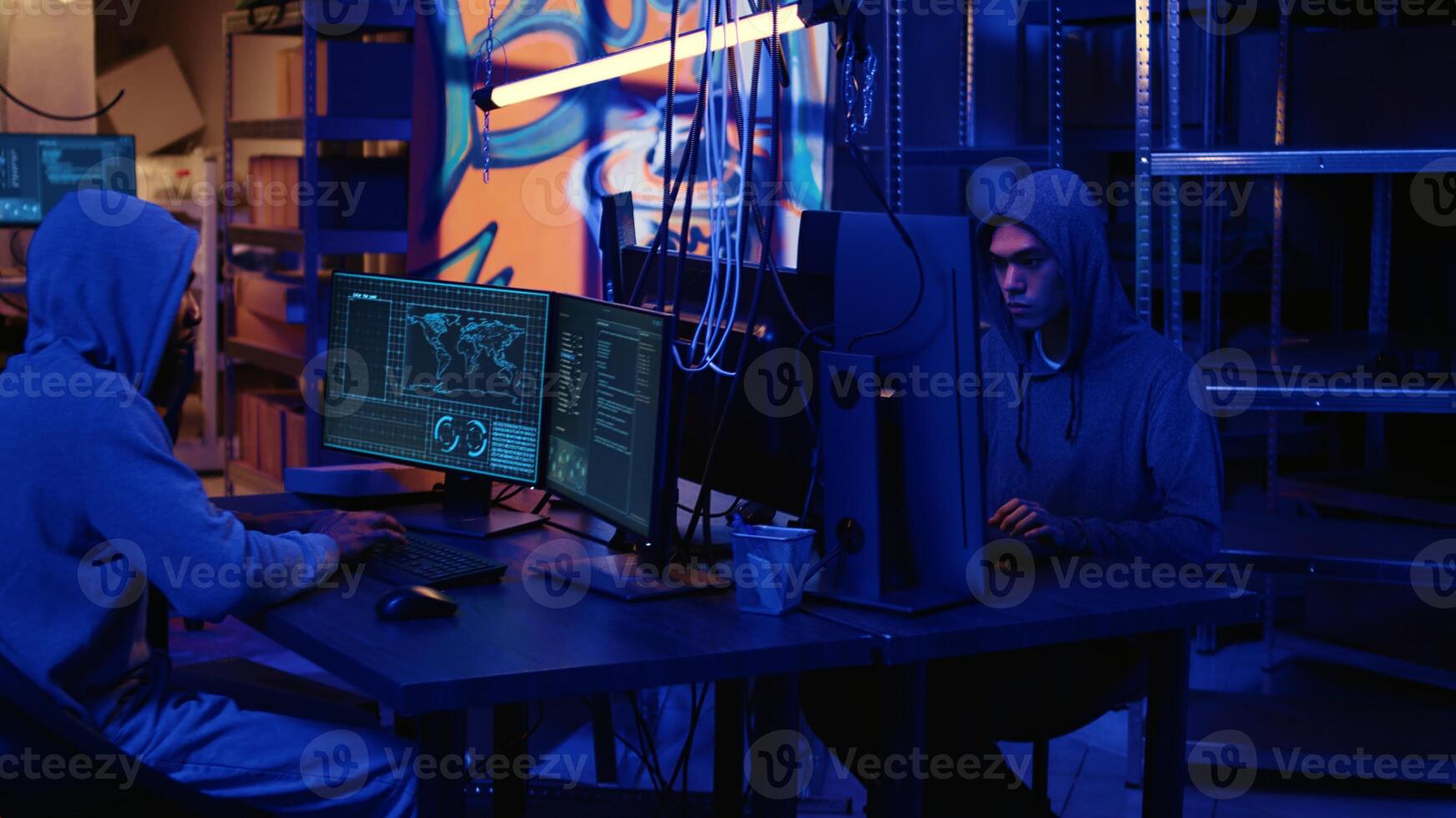Hackers in dark neon lit underground HQ coding malware designed to exploit network backdoors, using high tech tools to bypass security measures such as logins and password protections photo