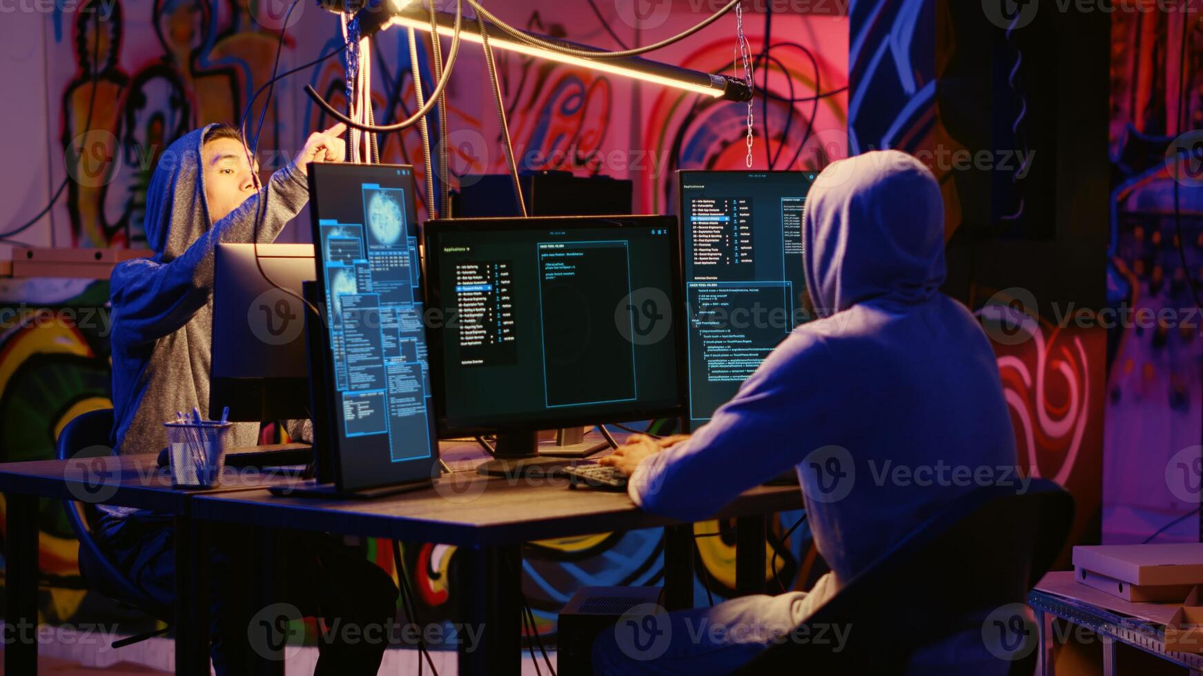 Hackers using network vulnerabilities to exploit servers, doing coordinated cyber attacks, trying to break computer systems at night. Cybercriminals work together on breaching networks photo