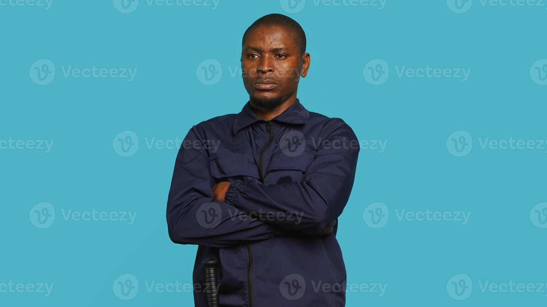 Security guard in threatening pose, tasked with preventing criminal activity and detaining suspects performing crimes. Portrait of menacing bodyguard crossing arms, studio background, camera A photo