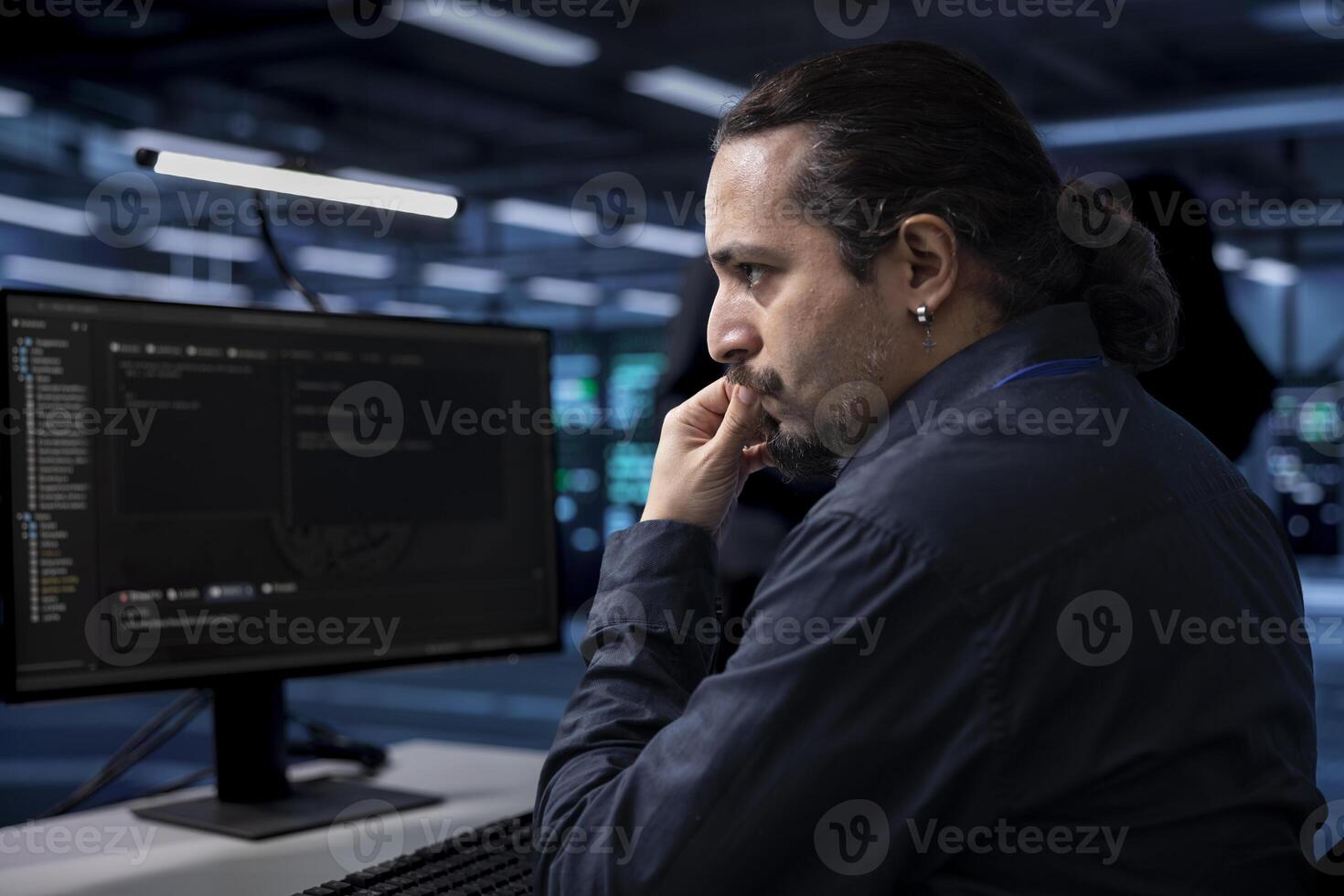 Computer scientist doing maintenance in server room to extend equipment life span and avoid downtime. IT professional monitoring rackmounts for overheating problems and power fluctuations photo