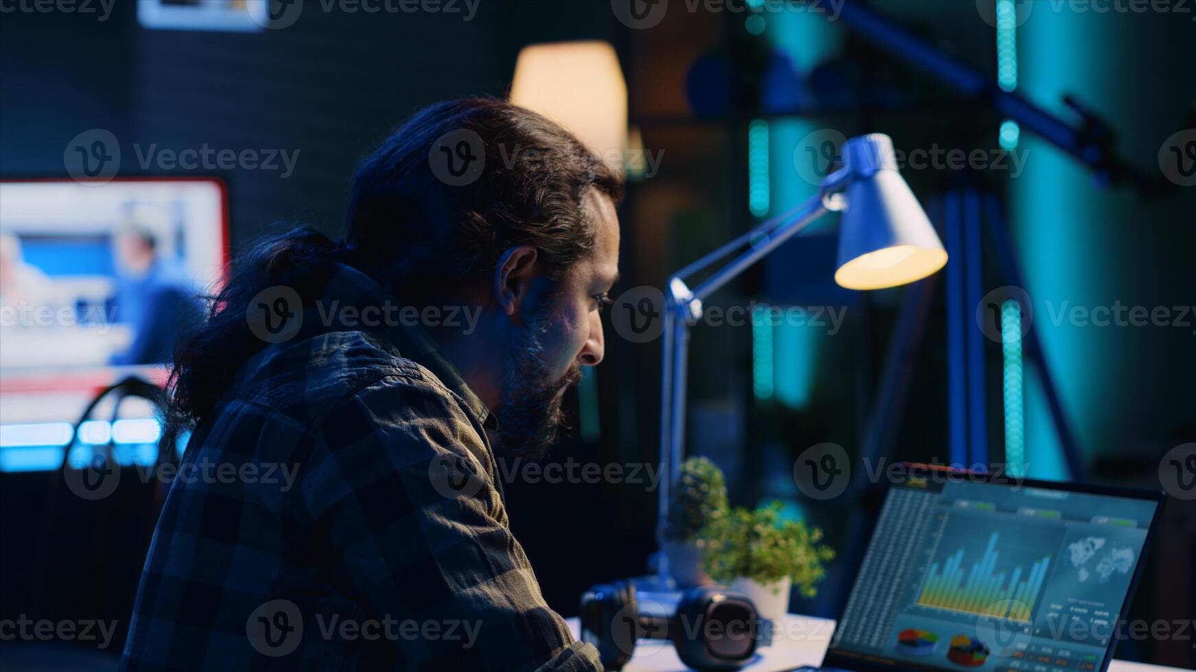 Smiling man satisfied about statistical data financial graphs on laptop screen while researching data. Remote worker happy about business graphic economic numbers, feeling pleased, camera A photo