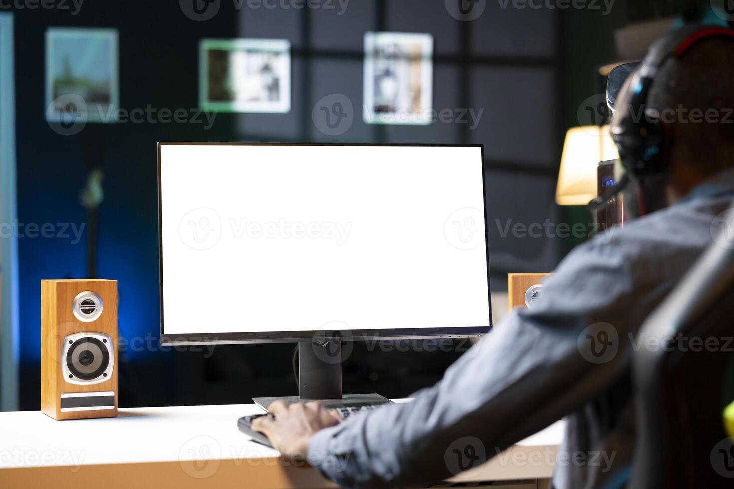 Gamer using headphones to discuss with mates while playing online videogame on isolated screen monitor. Man enjoying coop game with friends on mockup computer display, chatting on internet photo