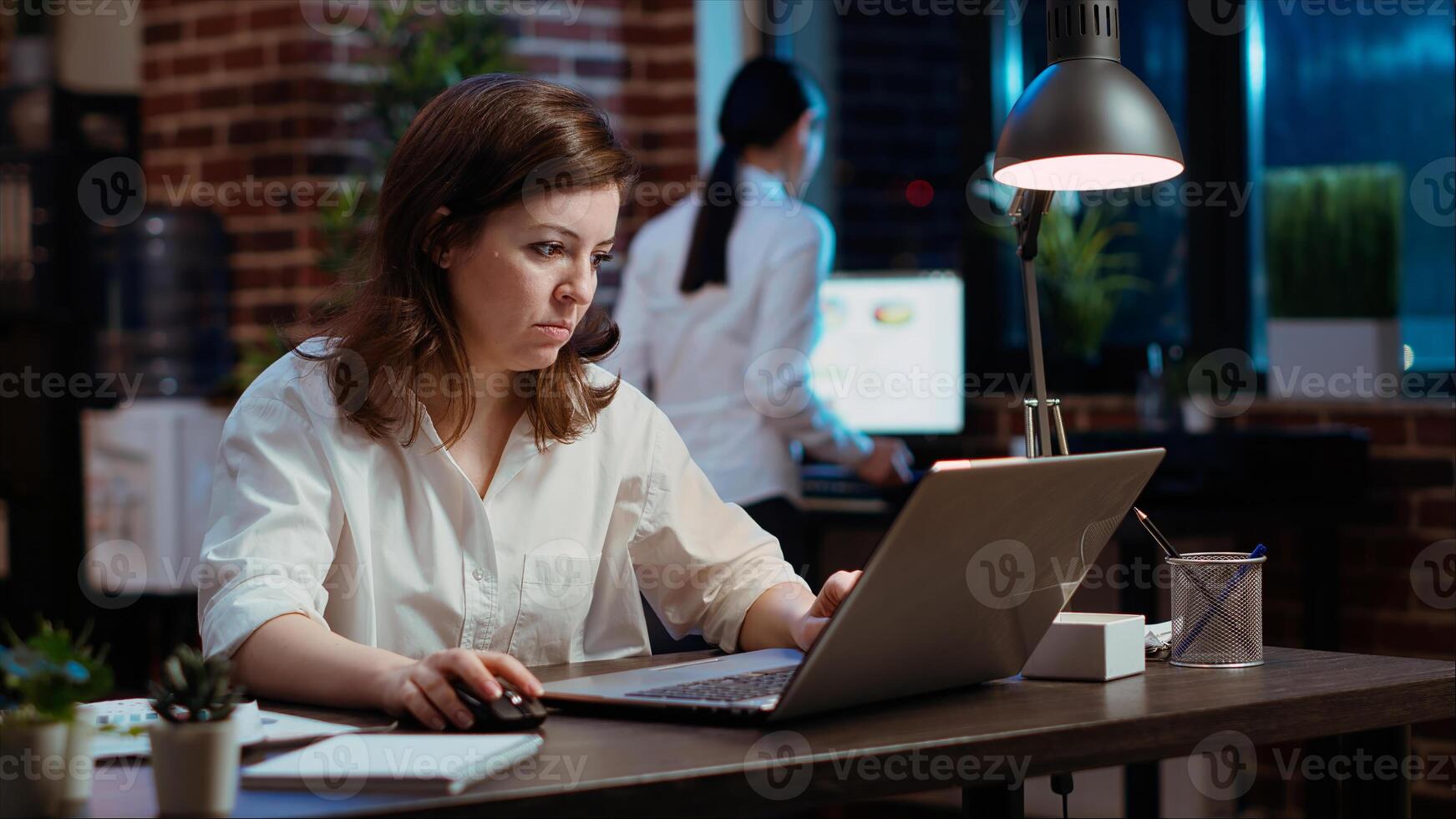 Businesswoman creating marketing project plan on laptop, writing necessary steps. Office employee working on strategy research to create financial development for company, camera B photo