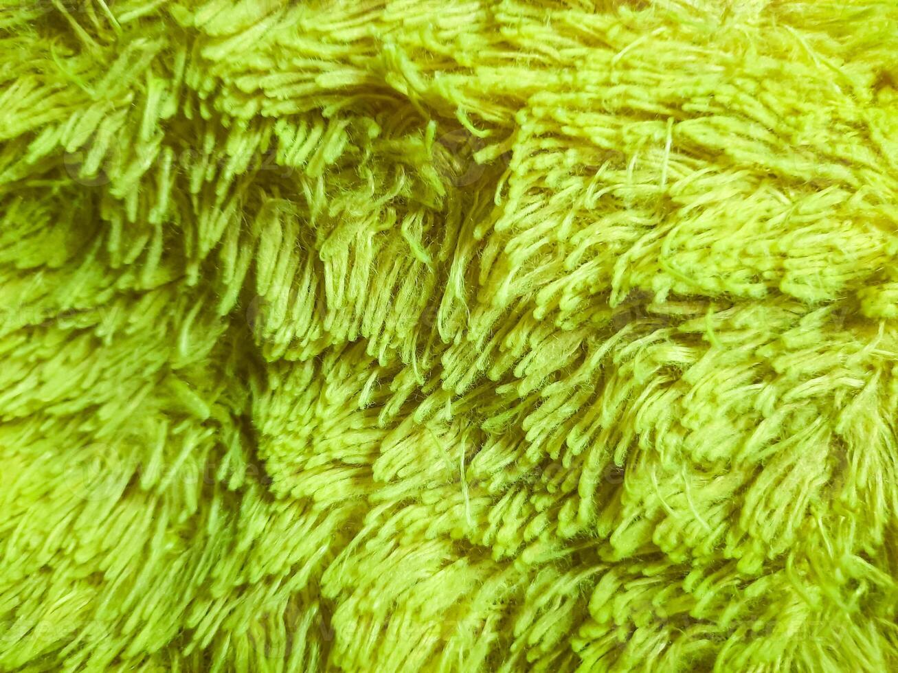Soft pillowcase texture made of wool yarn. Light green background photo