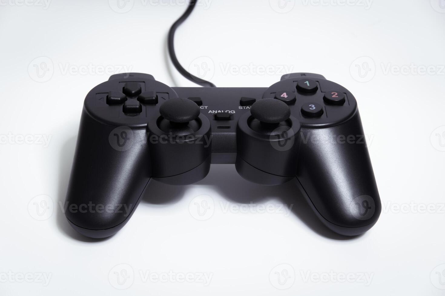 Black controller on white background, game device, Joystick on a white background. photo