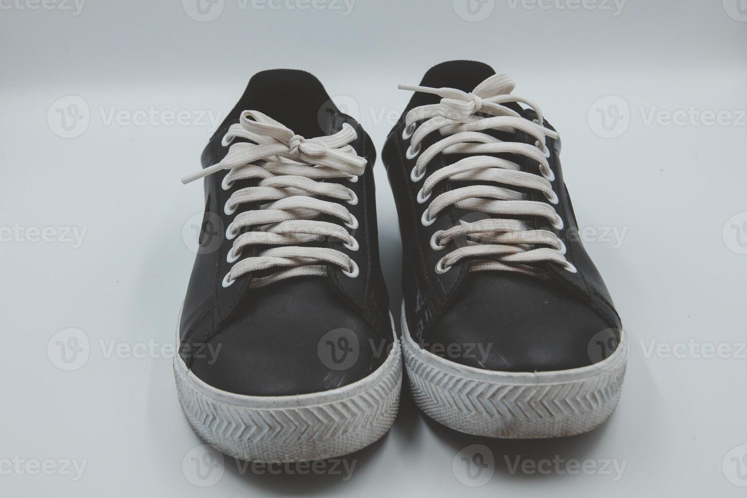 shoe sneaker on white background, close up of sneaker on white background, old black generic sneakers on white background. photo
