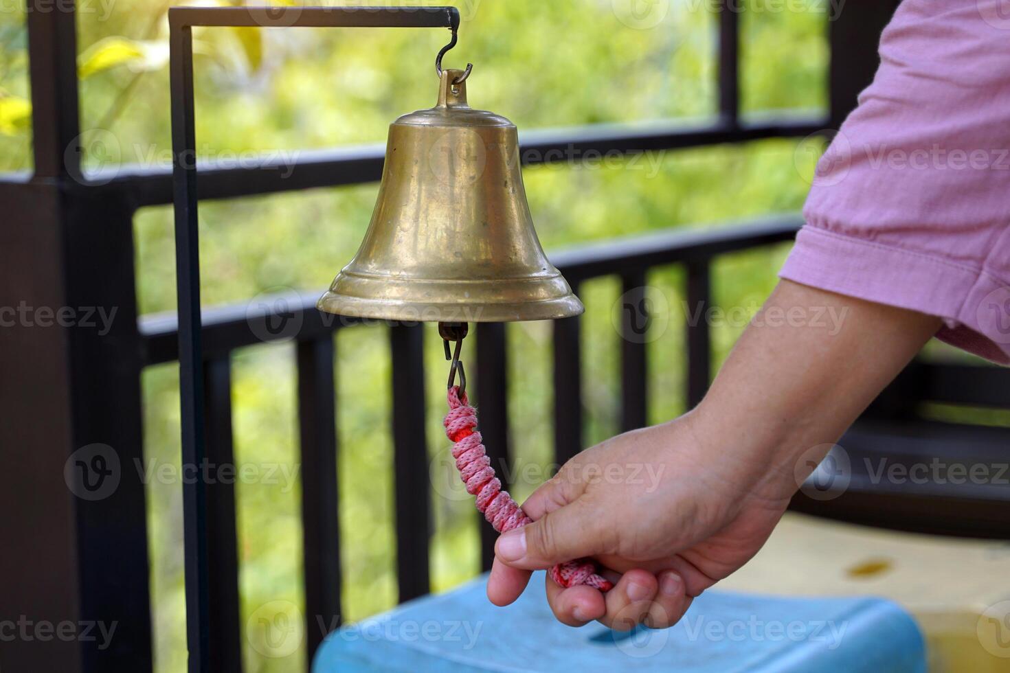 The handle of the rope rings a brass bell to tell the bus operating time. soft and selective focus. photo