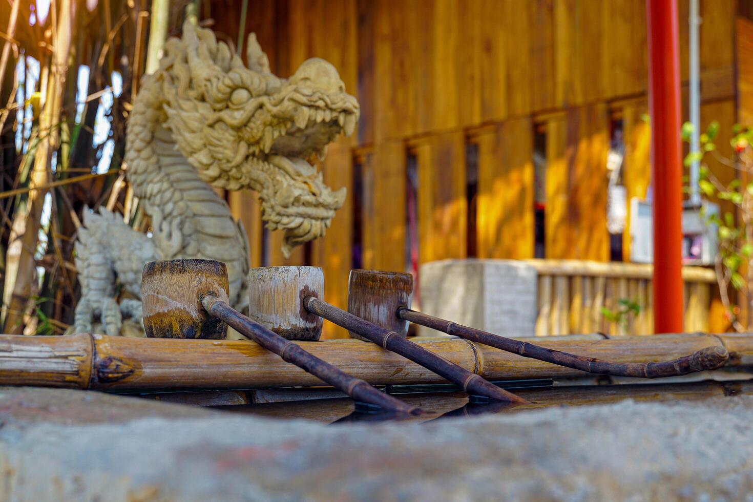 bamboo ladle is placed at a sacred pond in a Japanese shrine or temple. This is called shozuya. It is used to cleanse the body and mind before worship. photo