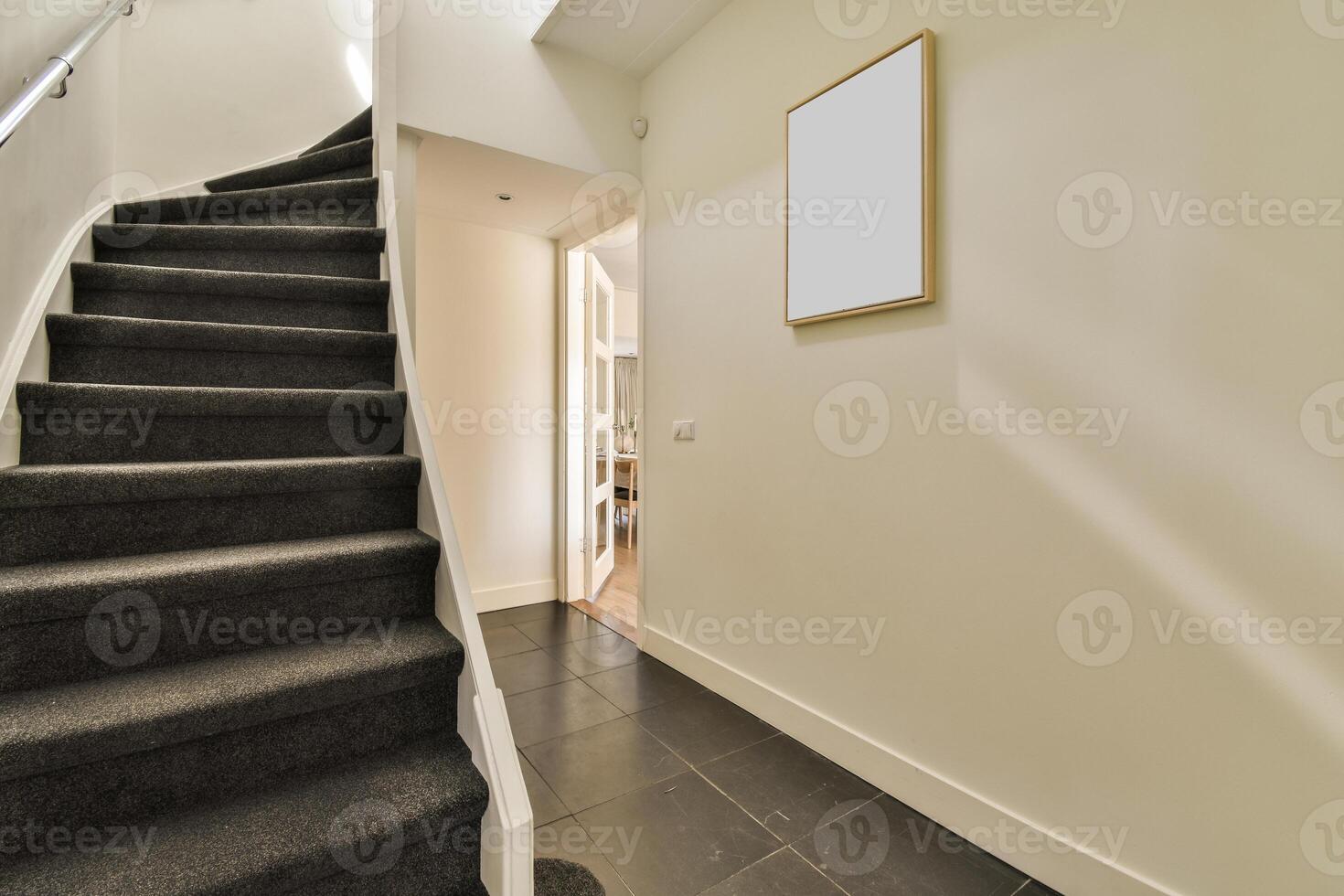 A black stairway with a white frame on the wall photo