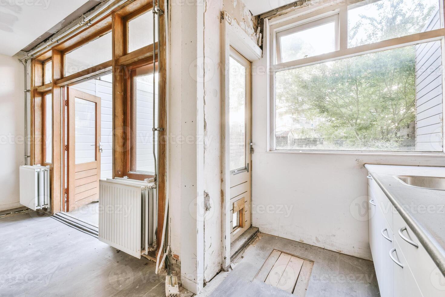An empty kitchen with a door and window photo