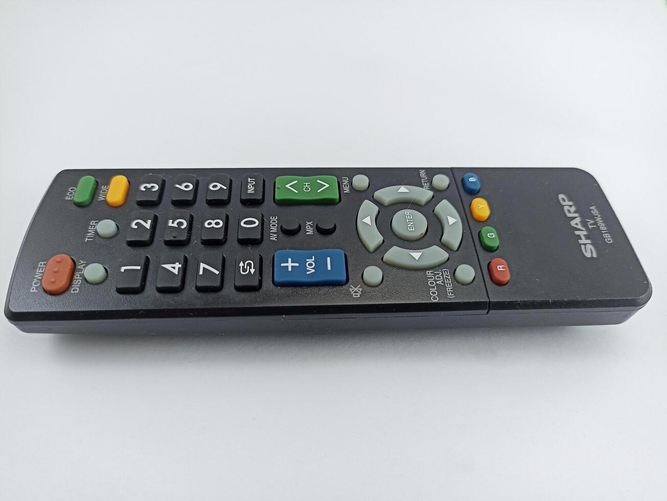 Wonosobo, Central Java Indonesia - August 9 2024 a sharp black TV remote control with a white background photo