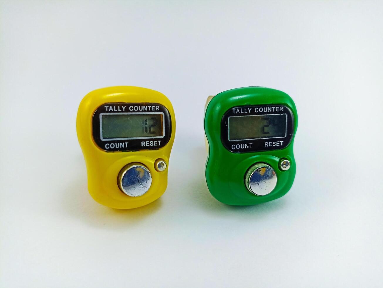 Wonosobo, Central Java, Indonesia - September 7, 2024 Digital hand tally counter in yellow and green on a white background photo
