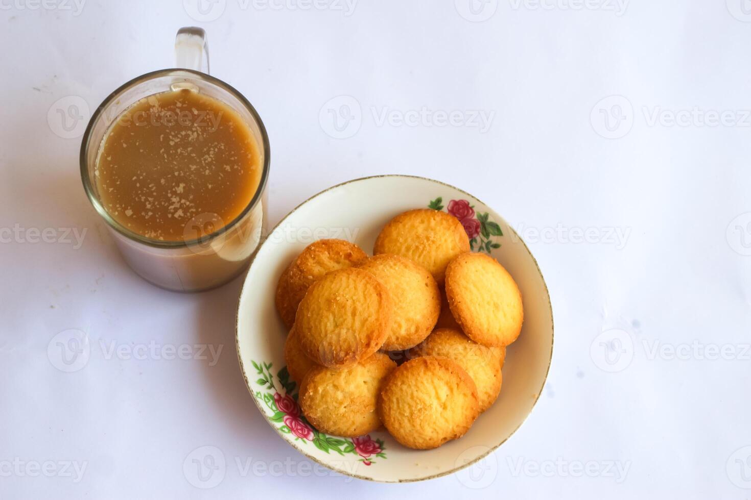 breakfast menu in the form of Danish butter cake and a glass of chocolate milk, Close up of butter cookies coated with white sugar and a glass of chocolate, sweet cake photo