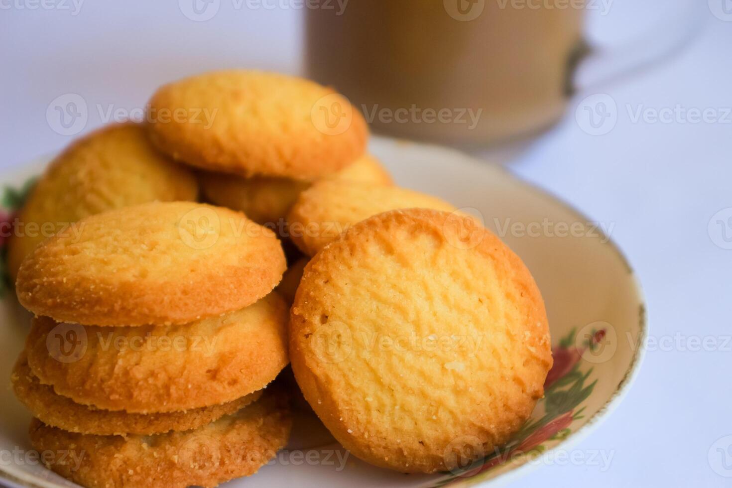 breakfast menu in the form of Danish butter cake and a glass of chocolate milk, Close up of butter cookies coated with white sugar and a glass of chocolate, sweet cake photo