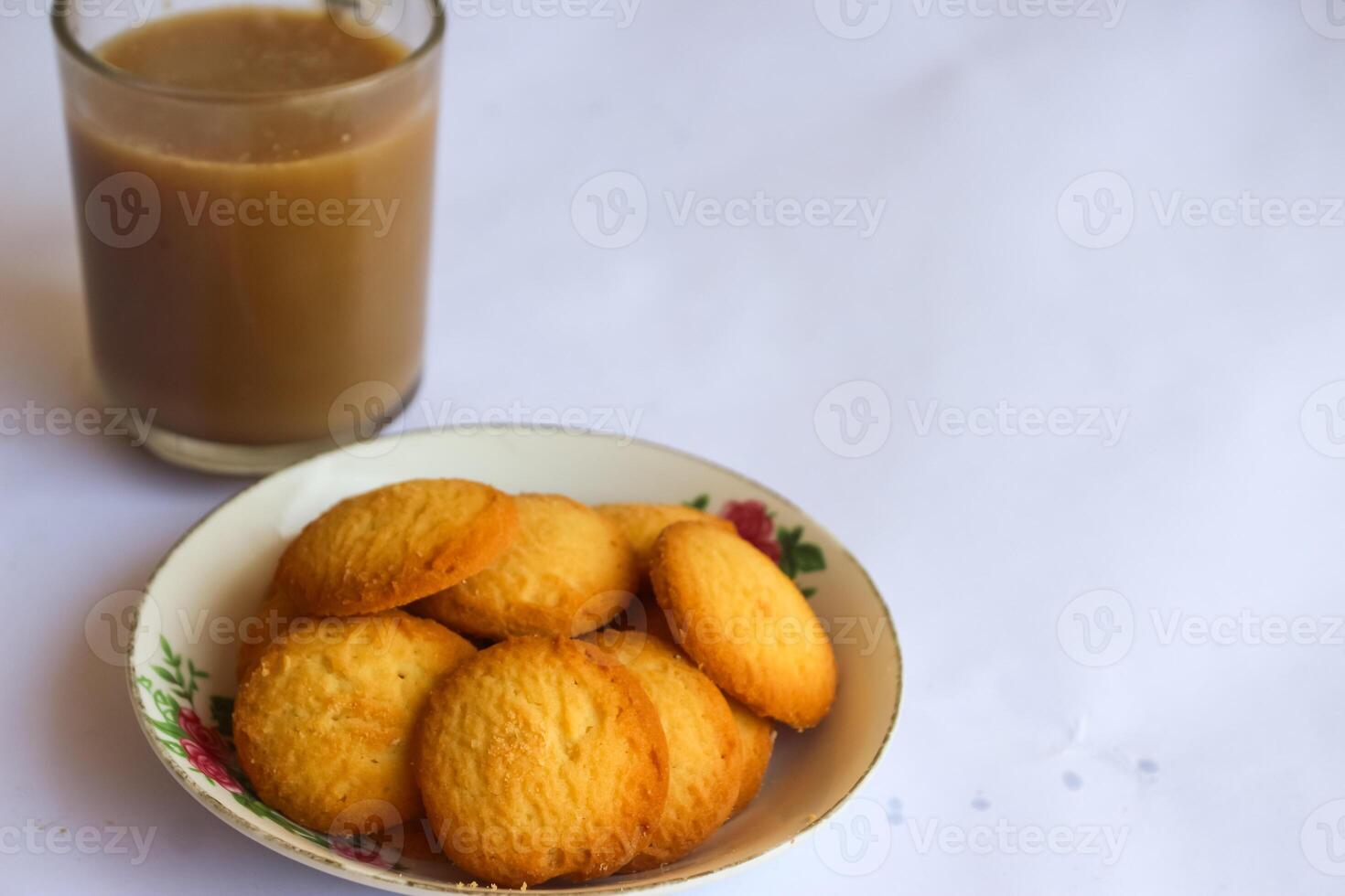 breakfast menu in the form of Danish butter cake and a glass of chocolate milk, Close up of butter cookies coated with white sugar and a glass of chocolate, sweet cake photo