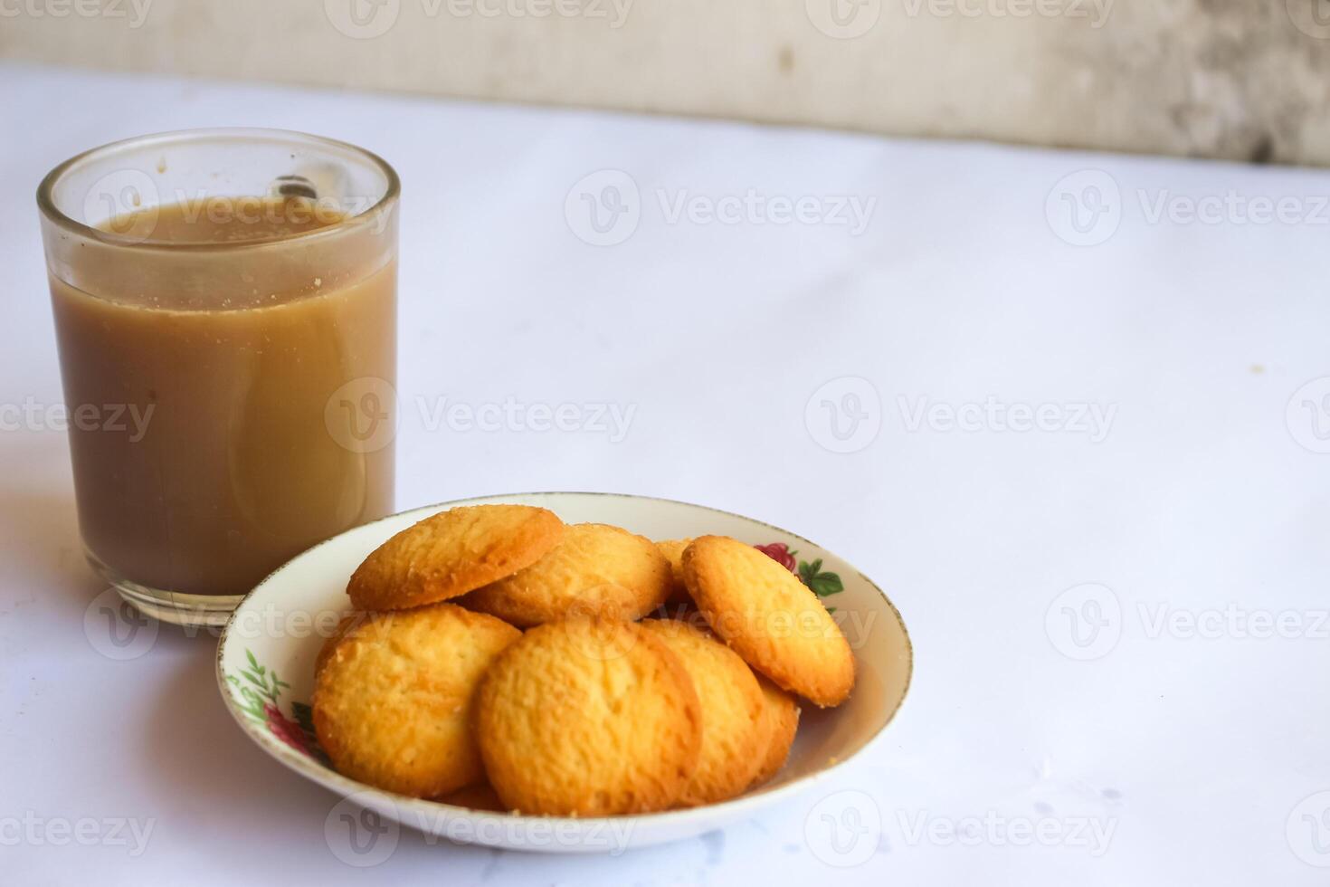 breakfast menu in the form of Danish butter cake and a glass of chocolate milk, Close up of butter cookies coated with white sugar and a glass of chocolate, sweet cake photo