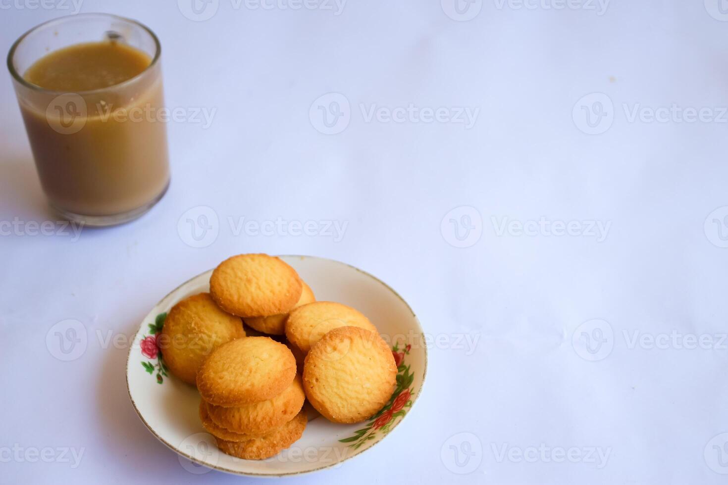 breakfast menu in the form of Danish butter cake and a glass of chocolate milk, Close up of butter cookies coated with white sugar and a glass of chocolate, sweet cake photo