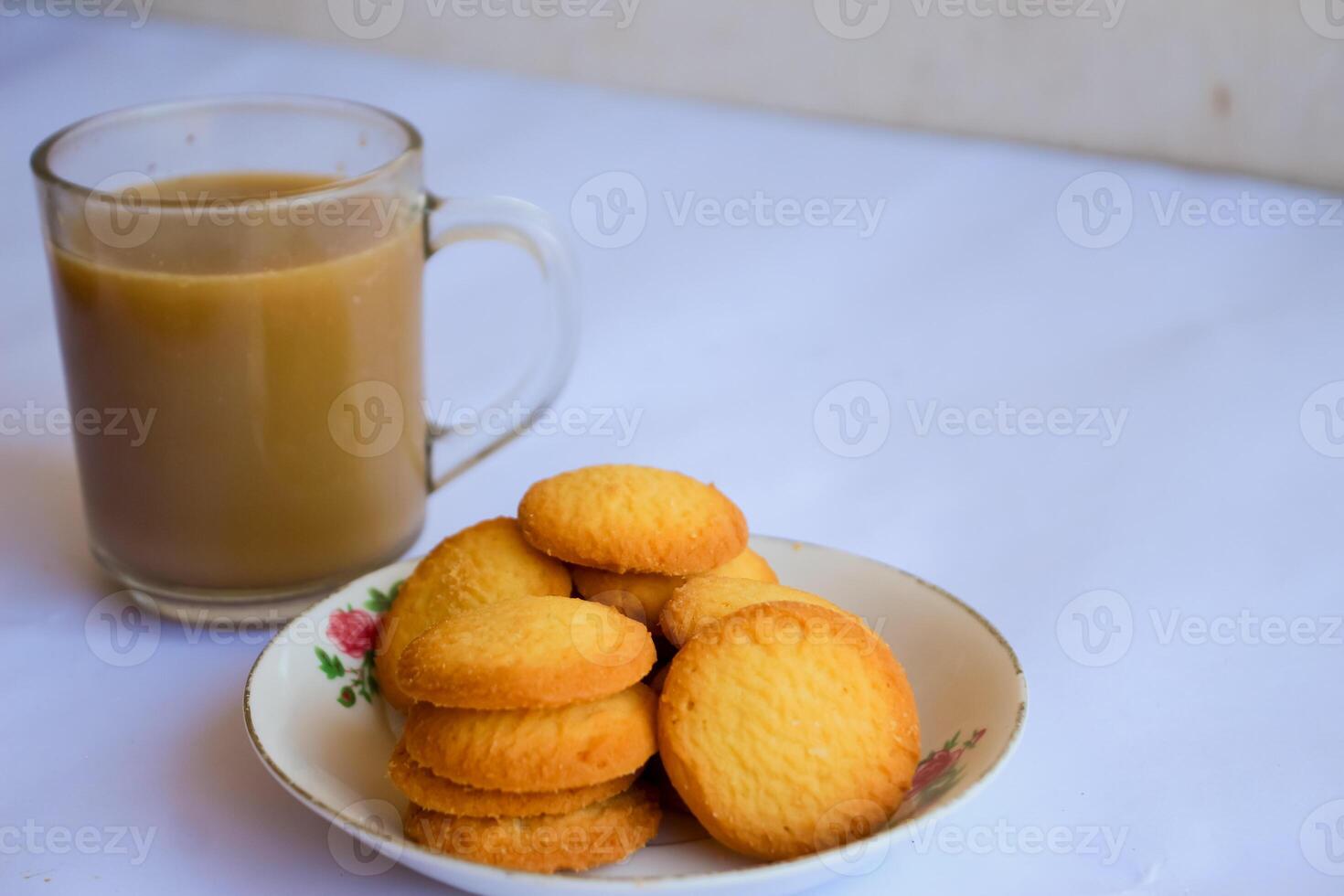 breakfast menu in the form of Danish butter cake and a glass of chocolate milk, Close up of butter cookies coated with white sugar and a glass of chocolate, sweet cake photo