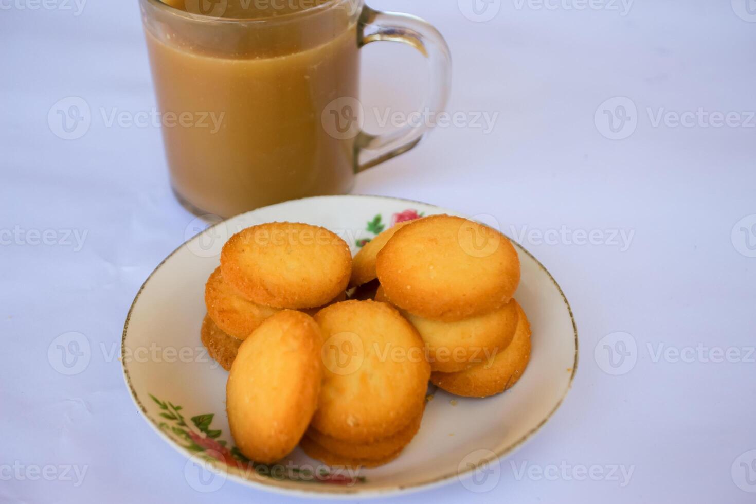 breakfast menu in the form of Danish butter cake and a glass of chocolate milk, Close up of butter cookies coated with white sugar and a glass of chocolate, sweet cake photo