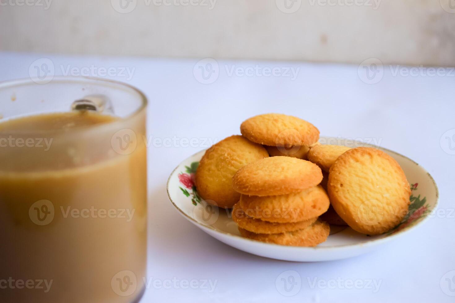 breakfast menu in the form of Danish butter cake and a glass of chocolate milk, Close up of butter cookies coated with white sugar and a glass of chocolate, sweet cake photo
