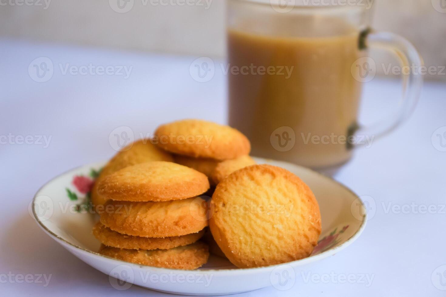 breakfast menu in the form of Danish butter cake and a glass of chocolate milk, Close up of butter cookies coated with white sugar and a glass of chocolate, sweet cake photo
