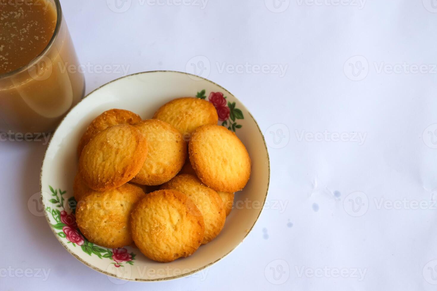 breakfast menu in the form of Danish butter cake and a glass of chocolate milk, Close up of butter cookies coated with white sugar and a glass of chocolate, sweet cake photo