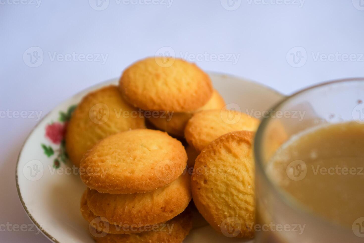 breakfast menu in the form of Danish butter cake and a glass of chocolate milk, Close up of butter cookies coated with white sugar and a glass of chocolate, sweet cake photo