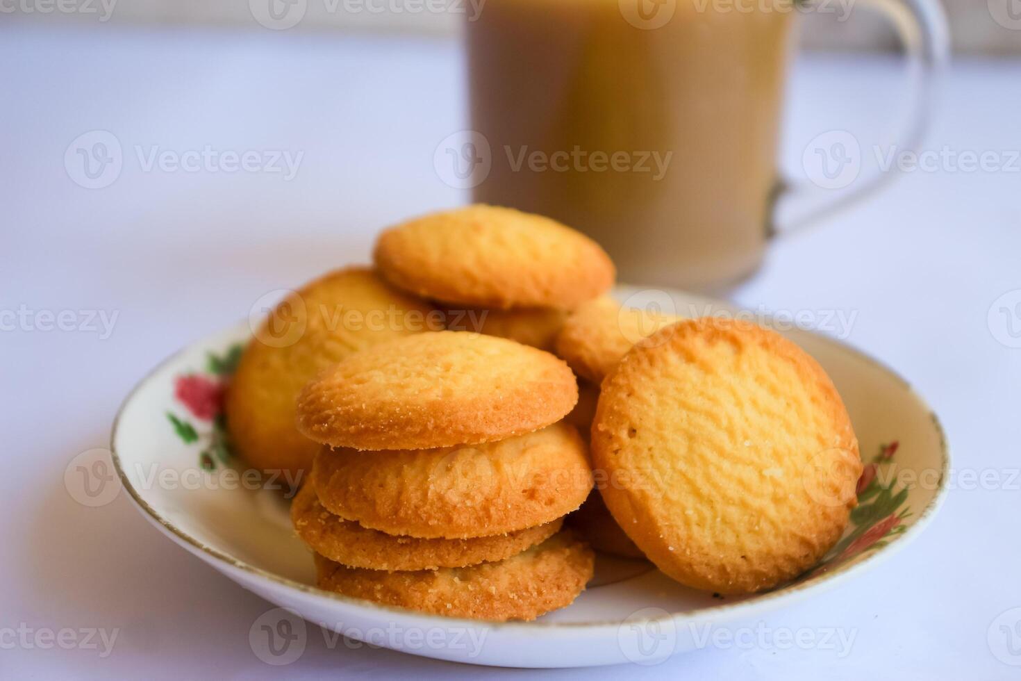 breakfast menu in the form of Danish butter cake and a glass of chocolate milk, Close up of butter cookies coated with white sugar and a glass of chocolate, sweet cake photo