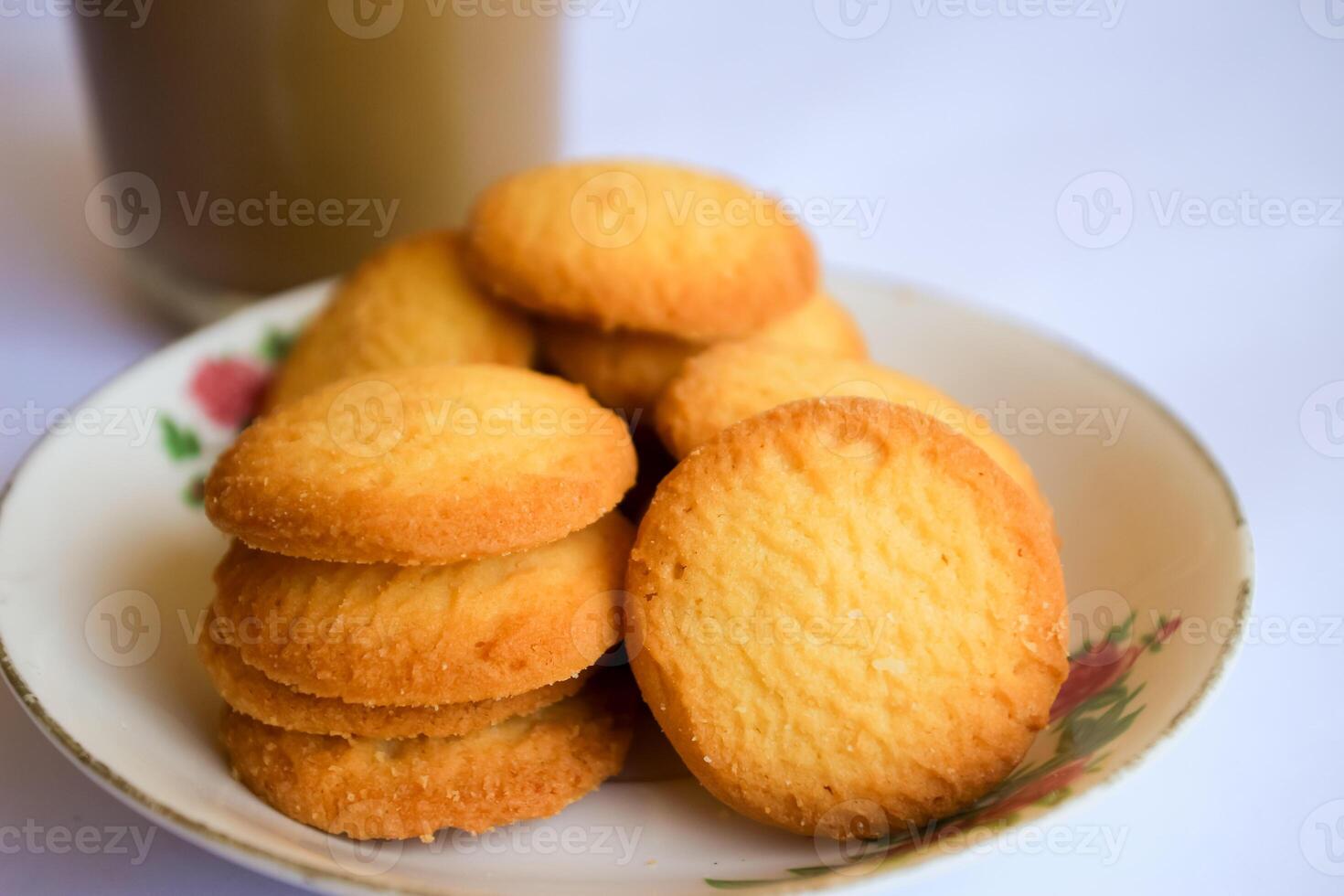 breakfast menu in the form of Danish butter cake and a glass of chocolate milk, Close up of butter cookies coated with white sugar and a glass of chocolate, sweet cake photo